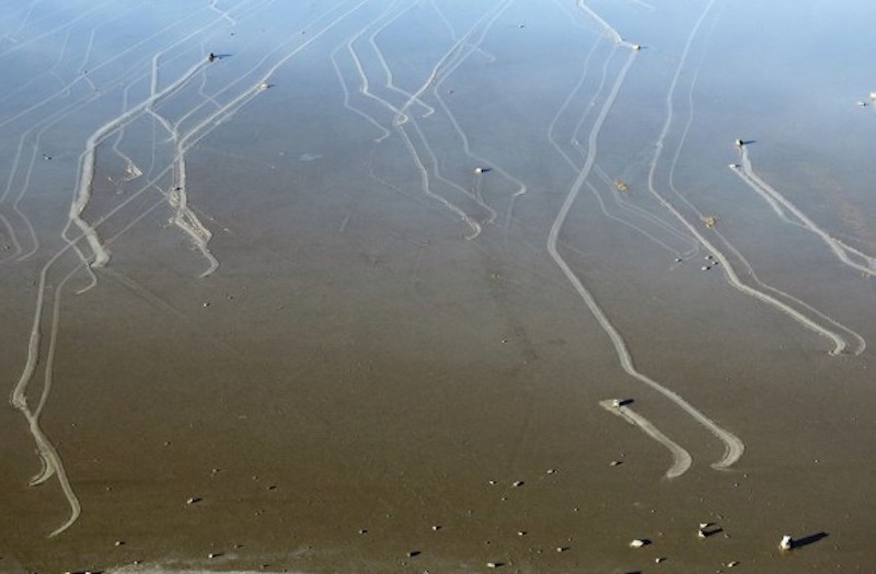 Eine Luftaufnahme der abgewinkelten Wege durch den Sand und einige mit Felsen an einem Ende.