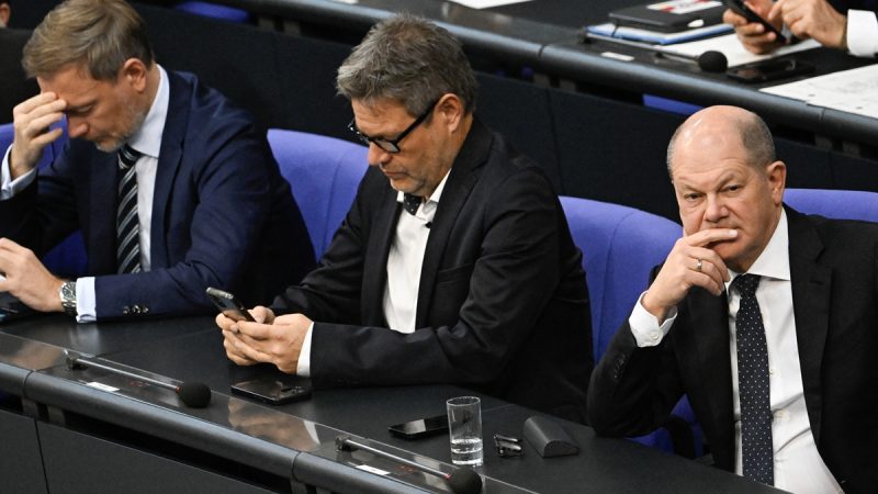 German Chancellor Olaf Scholz (right,) Minister of Economics and Climate Protection Robert Habeck (center) and Finance Minister Christian Lindner look on during a debate at the Bundestag about a budget crisis on November 28, 2023 in Berlin. German Chancellor Olaf Scholz vowed that his government will work 
